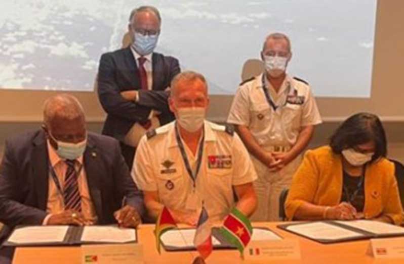 From left: Prime Minister, Brigadier (Ret’d) Mark Phillips; Brigadier General Régis Colcombet of France and Defence Minister of Suriname, Krishna Mathoera, sign a common security master plan