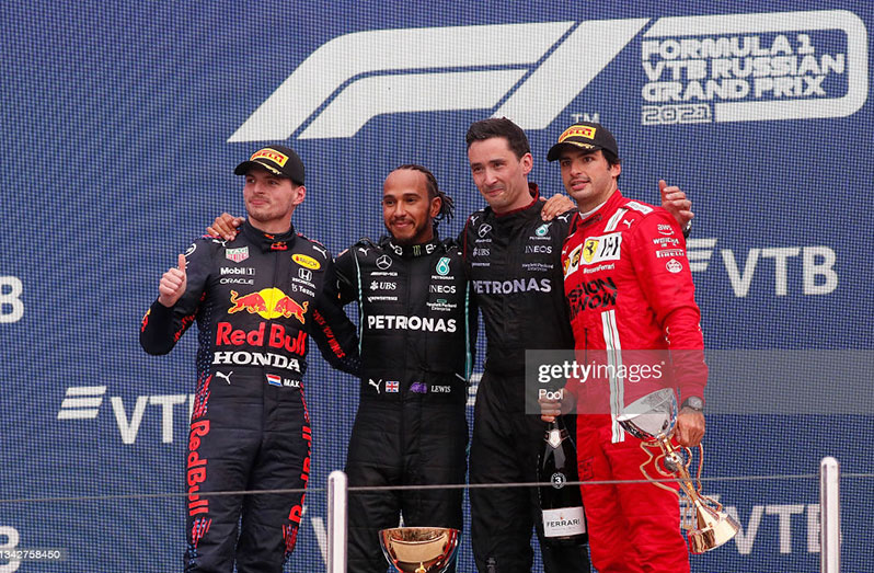 Race winner Lewis Hamilton of Great Britain and Mercedes GP; second placed Max Verstappen of Netherlands and Red Bull Racing, and third placed Carlos Sainz of Spain and Ferrari, celebrate on the podium during the F1 Grand Prix of Russia at Sochi Autodrom on September 26, 2021 in Sochi, Russia. (Photo by Yuri Kochetkov - Pool/Getty Images)