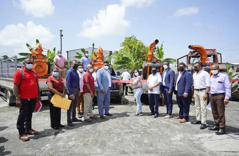 President Irfaan Ali officially handing over the boom sprayers. Also pictured are several government officials and rice industry stakeholders