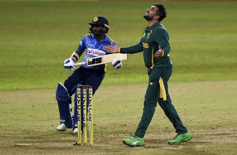 South Africa’s Tabraiz Shamsi ® celebrates after the dismissal of Sri Lanka’s Akila Dananjaya (L) during the second one-day international (ODI) cricket match between Sri Lanka and South Africa.