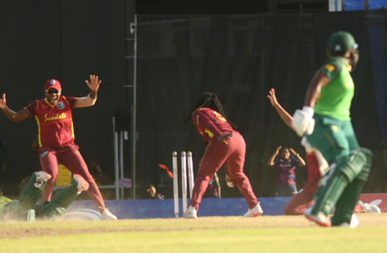 SUPER-OVER: Deandra Dottin breaks the stump off the last ball of the innings to force the super-over as Mignon du Preez (left) puts in a desperate dive. (Photo courtesy CWI Media)