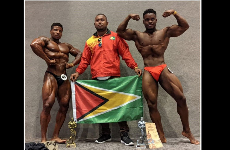 Darious Ramsammy (left) finished second overall at the Santo Domingo Open, while Nicholas Albert (right) finished second in his weight division.  Also in photo is coach/manager, Videsh Sookram