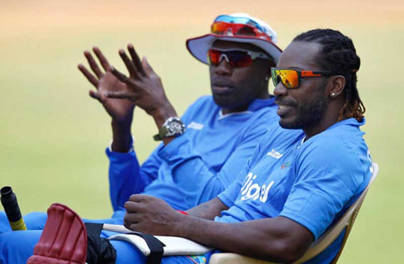 West Indies’ Chris Gayle, right, listens to team’s bowling coach Curtly Ambrose during a training session ahead of their ICC World Twenty20 2016 match against Sri Lanka in Bangalore, India, Saturday, March 19, 2016.