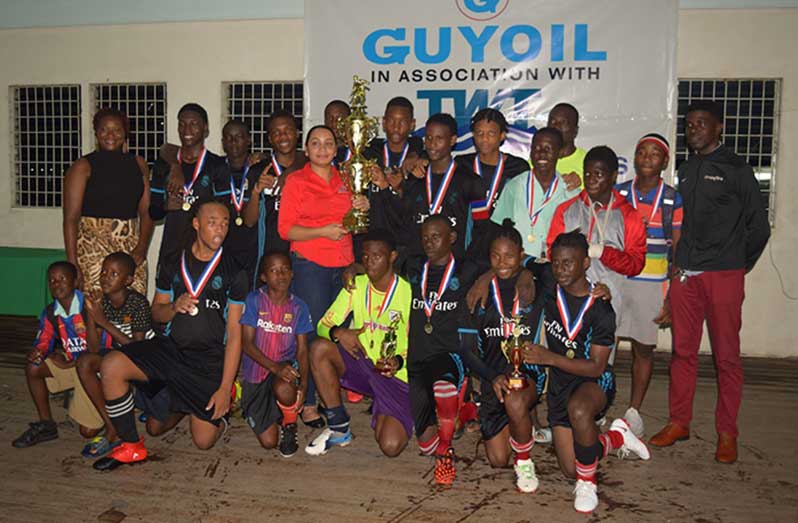 Flashback! Joshua Denny (front row,
third from left) celebrates with his
Lodge Secondary school team mates
after winning the 2019 TradeWind
Tankers football tournament