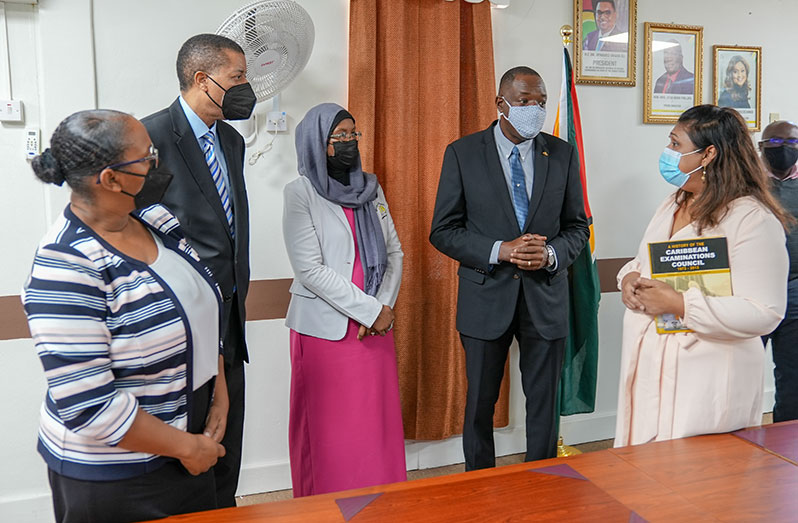 Minister of Education, Priya Manickchand (right) engages CXC Registrar and CEO, Dr. Wayne Wesley (second from right). Also pictured are (from left) CXC Director of Operations Examination Services, Dr. Nicole Manning; CXC Corporate Communications Manager, Richard Rose; and MoE Superintendent of Examinations, Sauda Kadir