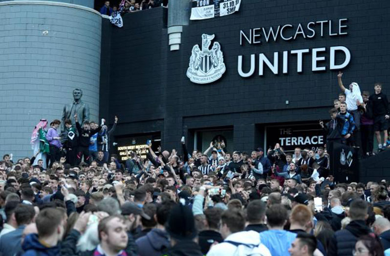 Newcastle fans gather at St James' Park to celebrate Saudi takeover.