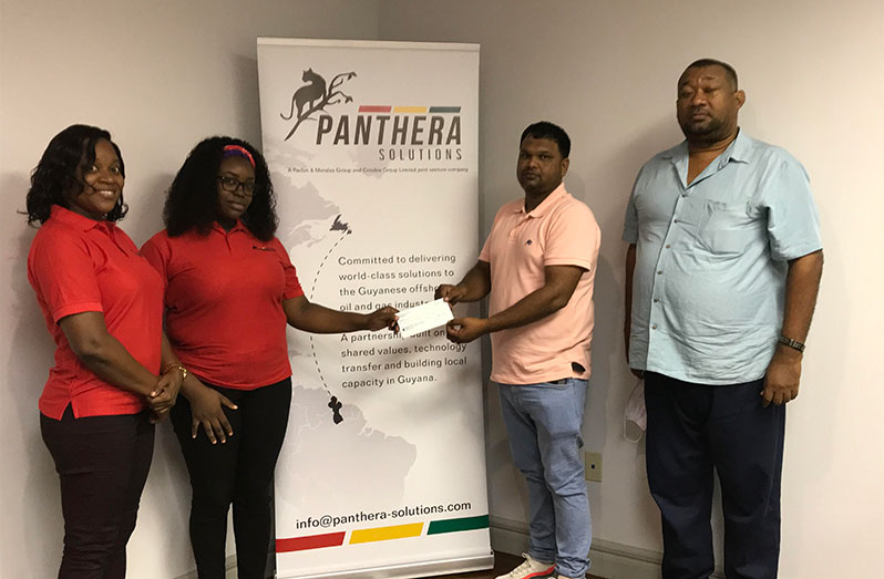 RHTYSC vice-president Mark Papannah receives donation from two representatives of Panthera Solutions while Club Secretary/CEO Hilbert Foster looks on.