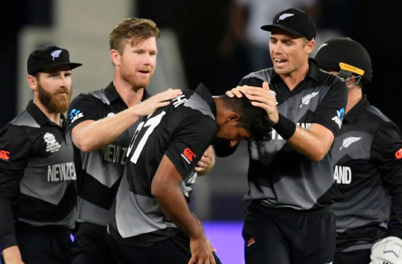 Ish Sodhi is mobbed by his teammates after getting the wicket of Virat Kohli AFP/Getty Images