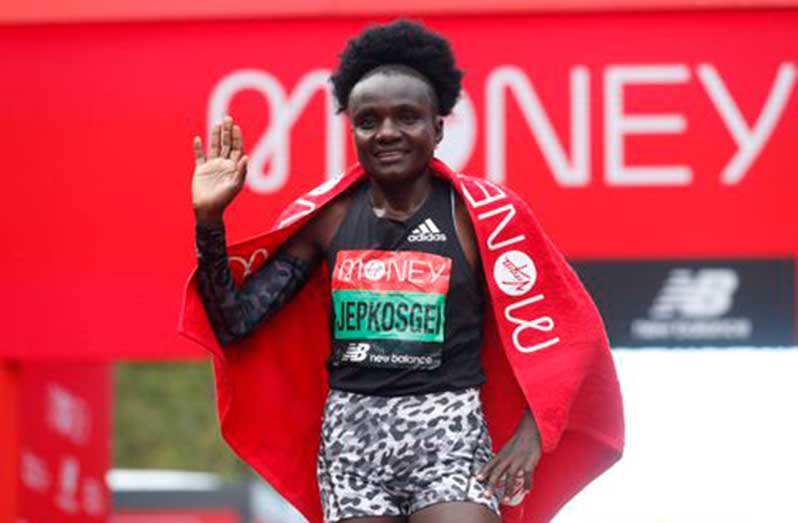 Kenya's Joyciline Jepkosgei celebrates winning the Women's race in the London Marathon in central London, Sunday