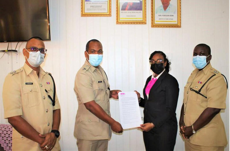 Acting Deputy Commissioner (Administration), Calvin Brutus, exchanged the signed MoU with Accounting Assistant of Cacique Accounting College, Suzanna Das. He was flanked by two senior police ranks