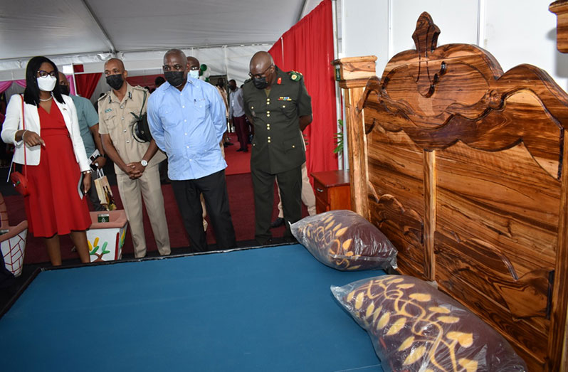  From left: Permanent Secretary within the Ministry of Home Affairs, Ms. Mae Toussaint Jr.;  Director of Prison (ag), Mr. Nicklon Elliot; Minister of Home Affairs, Hon. Robeson Benn and Chief-of-Staff of the Guyana Defence Force (GDF), Brigadier Godfrey Bess, take a closer look at one of the beds made by the prisoners at the exhibition.