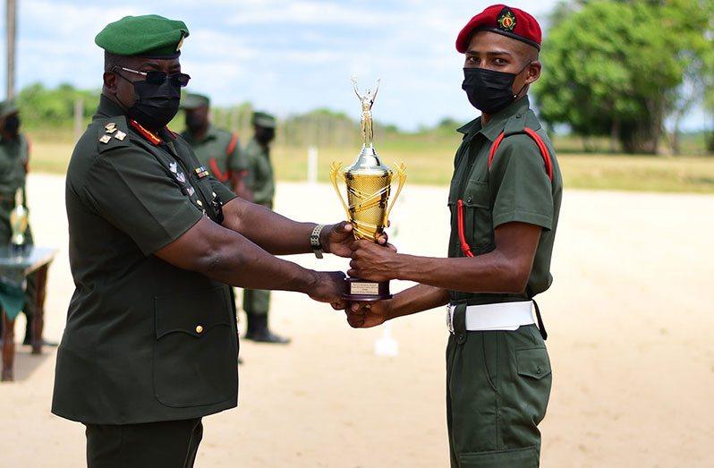Best Graduating Student, Private Hicks Mittleholzer receives a trophy from Chief of Staff, Brigadier Godfrey Bess