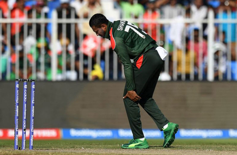 Shakib Al Hasan clutches his left hamstring while bowling during the game against West Indies  (AFP/Getty Images)