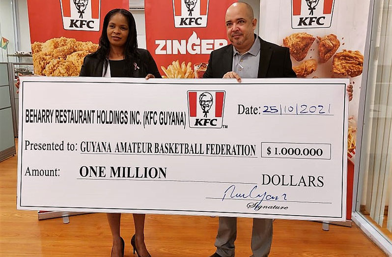 KFC Guyana’s Petall Manasseh presenting the company’s cheque to GABF president, Michael Singh