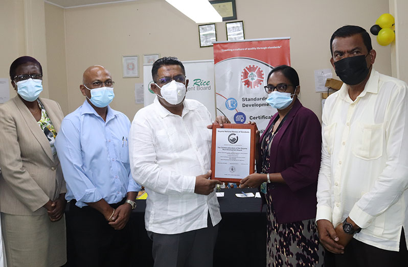 Agriculture Minister Zulfikar Mustapha receives the certification plaque from a Guyana National Bereau of Standards’ representative in the presence of other Ministry of Agriculture officials