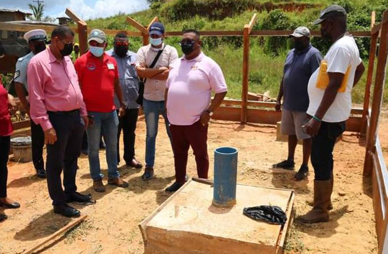 Minister of Housing and Water, Collin Croal and other officials inspect the well site at Oronoque in Region One
