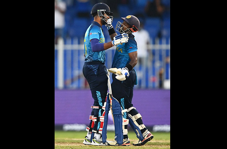 Dasun Shanaka congratulates Charith Asalanka after the win, Bangladesh vs Sri Lanka, T20 World Cup, Group 1, Sharjah, October 24, 2021 © ICC via Getty