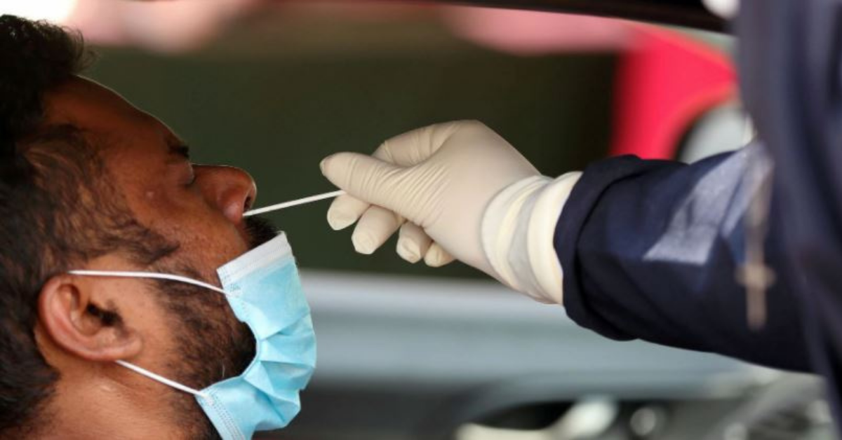 A health worker tests a motorist at a drive trough COVID-19 testing site, amid a nationwide coronavirus disease (COVID-19) lockdown, at a Dis-Chem pharmacy in Midrand, South Africa, January 18, 2021. REUTERS/Siphiwe Sibeko