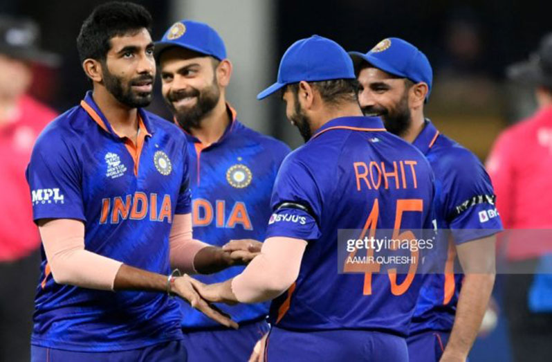 India's Jasprit Bumrah (left) celebrates with teammates after taking the wicket of Namibia's Michael van Lingen (not pictured) during the ICC Men's Twenty20 World Cup cricket match between India and Namibia at the Dubai International Cricket Stadium in Dubai on November 8, 2021. (Photo by Aamir QURESHI/AFP)