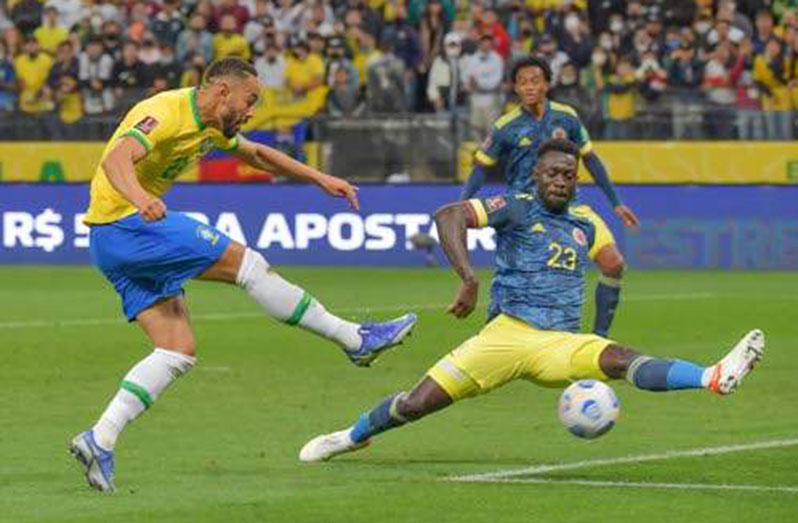 Brazil's Cunha (left) shoots as Colombia's Davinson Sanchez attempts to block during their South American qualification football match for the FIFA World Cup Qatar 2022, at the Neo Quimica Arena in Sao Paulo, Brazil, on Thursday. (Photo: AFP)