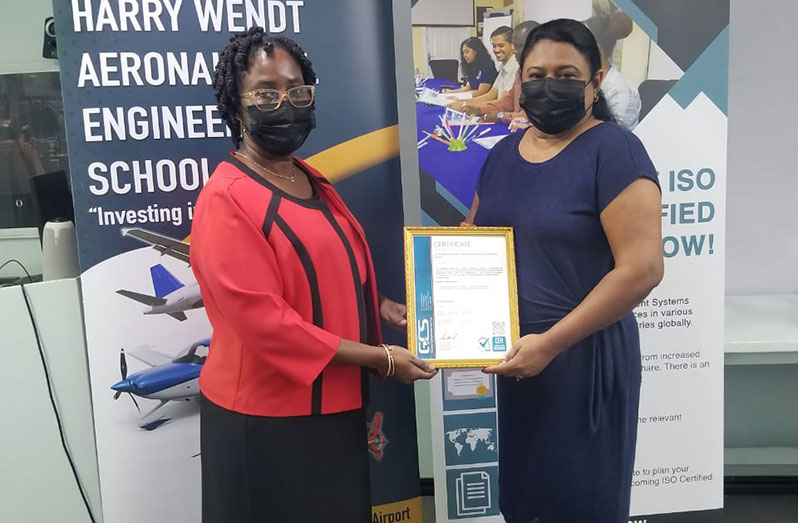Nalini Chanderban receives the ISO 9001 certificate from Chief Executive officer of Global Compliance Service, Candelle Bostwick