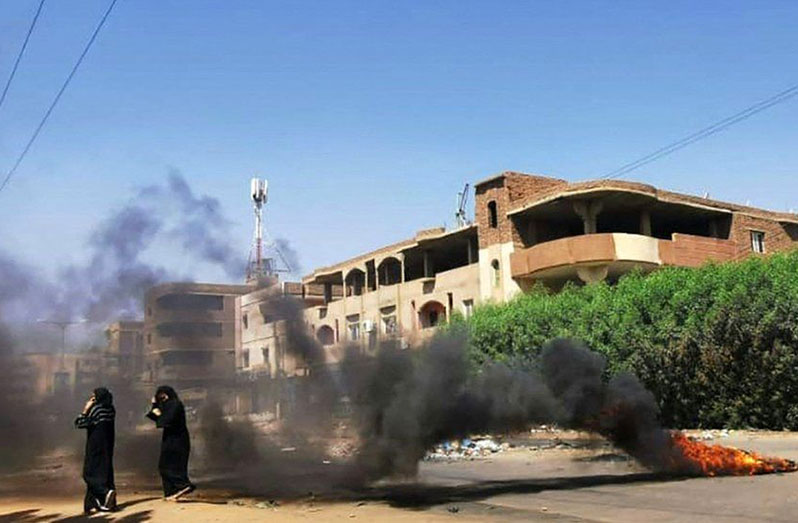 Protesters were burning tyres in Khartoum on Sunday (BBC/AFP photo)