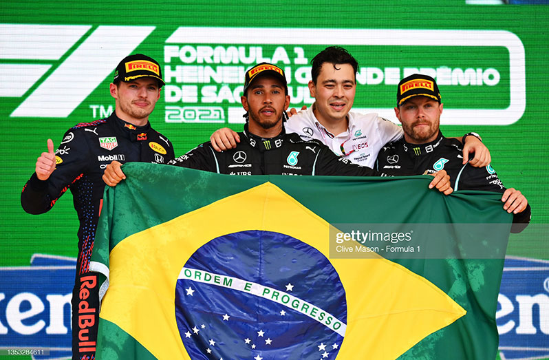 SAO PAULO, BRAZIL - NOVEMBER 14: Race winner Lewis Hamilton of Great Britain and Mercedes GP; second placed Max Verstappen of Netherlands and Red Bull Racing; and third placed Valtteri Bottas of Finland and Mercedes GP, celebrate on the podium during the F1 Grand Prix of Brazil at Autodromo Jose Carlos Pace on November 14, 2021 in Sao Paulo, Brazil. (Photo by Clive Mason - Formula 1/Formula 1 via Getty Images)