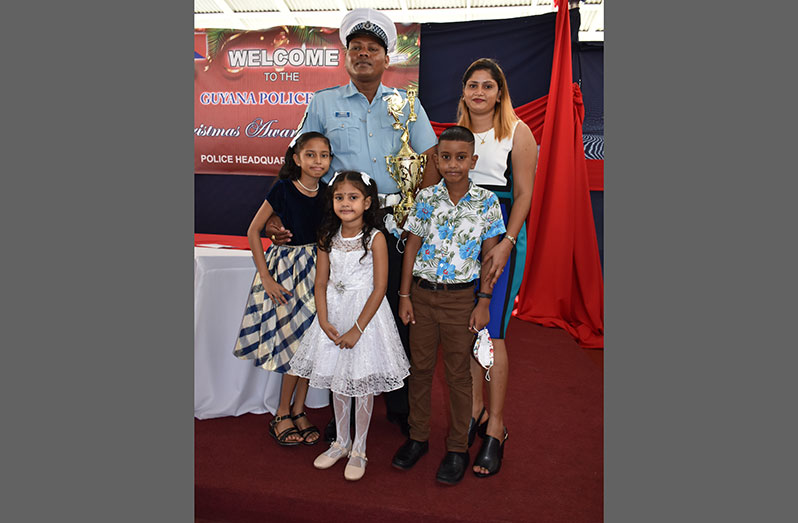 ‘Best Cop,’ Sergeant Moalchand Jadunandan along with his wife and three children at the Guyana Police Force’s Christmas awards ceremony, on Thursday (Elvin Croker photo)