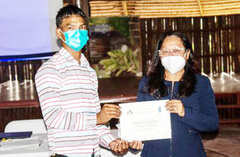 Amerindian Affairs Minister, Pauline Sukhai, presenting one of the village leaders with a certificate (DPI photo)
