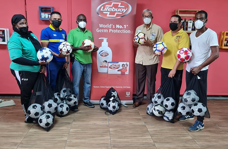 DeSinco Managing Director. Frank DeAbreu (3rd right), and EBFA vice-president Clayton Lambert (3rd left) are joined by other EBFA officials at the presentation