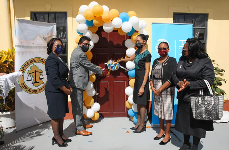 Helping Attorney-General and Minister of Legal Affairs Anil Nandlall (second left) do the honours of declaring open the New Amsterdam hearing rooms are: Chancellor of the Judiciary (ag), Justice Yonette Cummings-Edwards (left); and Ms. Patricia Gittens of UNICEF; Chief Justice Roxane George; and Her Worship, Chief Magistrate Ann McLennan, third, second and first right respectively