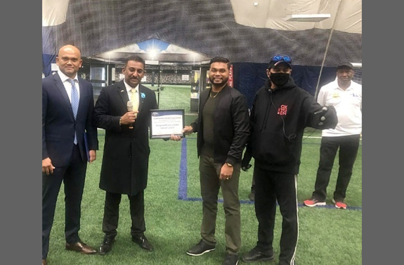 Ajax Ward 2 Councillor, Ashmeed Khan (left), hands over a certificate of recognition, on behalf of Mayor Shaun Collier, to SCA president Shiv Persaud