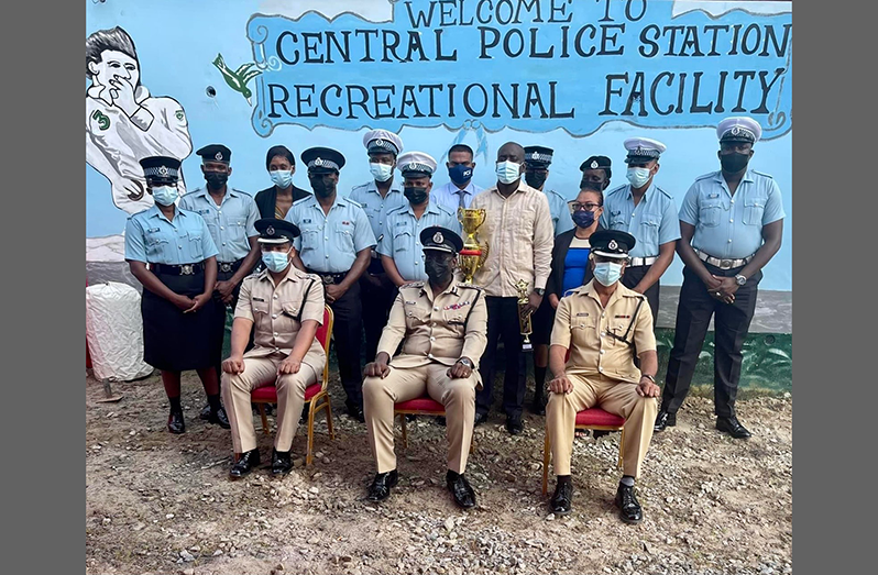Commissioner of Police (ag), Nigel Hoppie (centre), Deputy Commissioner (Administration), Calvin Brutus (left), Commander of Region 6, Jairam Ramlakhan (right), Best Cop Jamine Bacon (with trophies) and the 12 ranks who received on-the-spot promotion