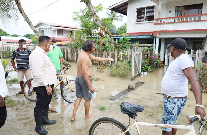 Agriculture Minister Zulfikar Mustapha assessing the impact of flooding in Zeelugt, Region Three, on Tuesday (DPI photo)