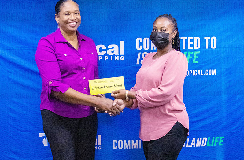 Country Manager, Tropical Shipping, Glenis Hodge making the presentation to graduate DHM, Kizzy Howell of Redeemer Primary School
