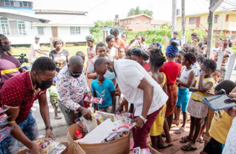 Minister within the Office of the Prime Minister with responsibility for Public Affairs, Kwame McCoy selecting toys to give the children (DPI photo)