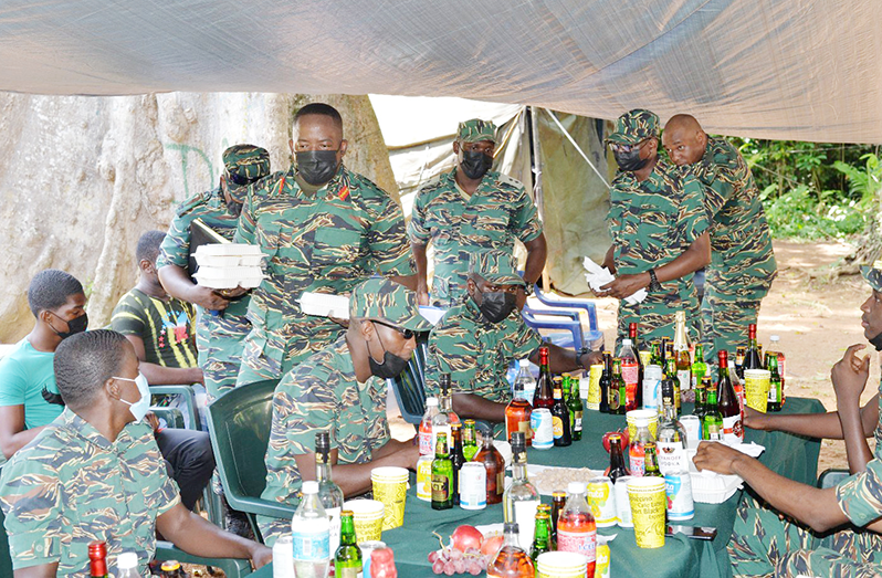 Chief of Staff, Brigadier Godfrey Bess serves lunch to the ranks at the location