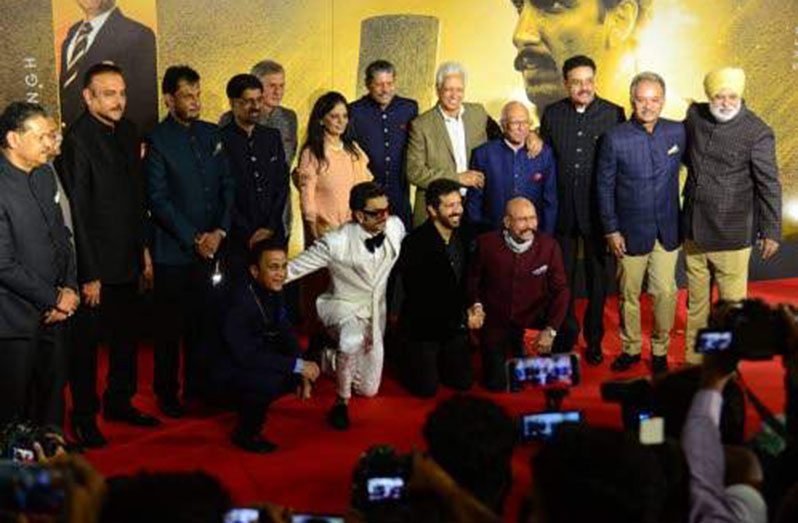 Bollywood film actor Ranveer Singh (second left, bottom) along with former 1983 World Cup team members pose for pictures during the premiere of the movie 83, which is based on India's first cricket world Cup victory in the year 1983, directed by Kabir Khan (second right, bottom) in Mumbai, on Wednesday, December 22, 2021. (Photo; AFP)