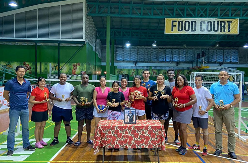 The respective winners of Trophy Stall Badminton Christmas Tournament with executive members of the Guyana Badminton Association