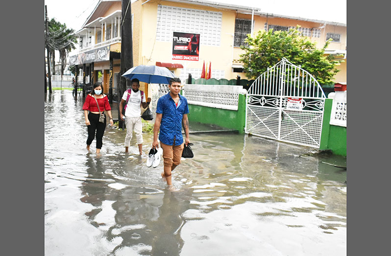 City residents navigate their way through the accumulated water (Carl Croker photo)