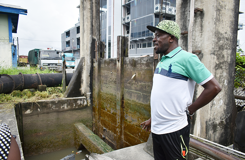 A sluice attendant stands next to one of the city sluices (Elvin Croker photo)