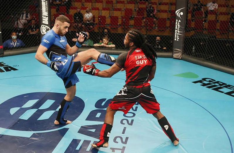 Ireland’s Adam McEnroe connects a vicious kick during his Welterweight clash against Guyana's Corwin D'Anjou.