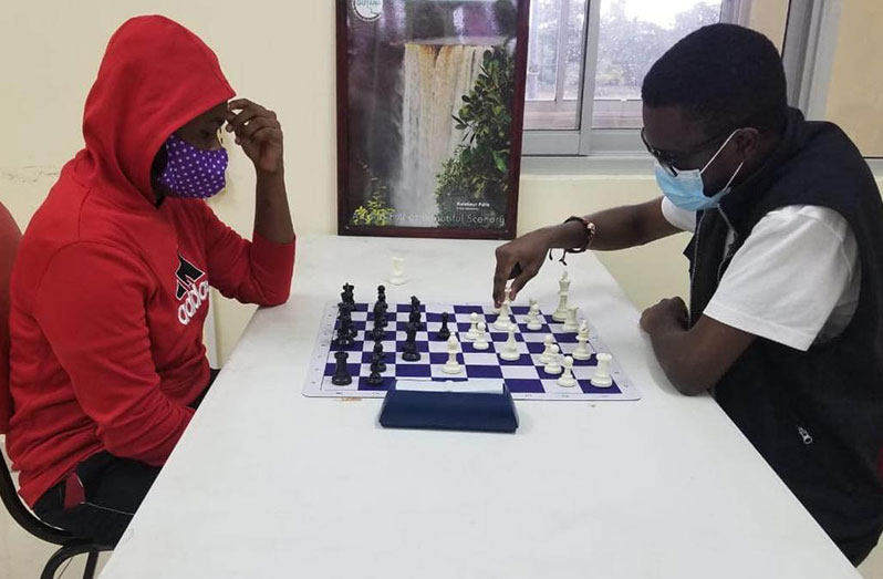 Flashback: Senior Blitz champion Davion Mars (right) makes a move against second-place finisher and Junior Blitz champion Keron Sandiford in the 2020 over-the-board championship.