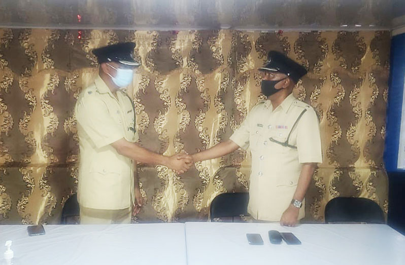 Superintendent Jairam Ramlakhan (left) shares a moment with the new Commander of Region Six, Superintendent Boodnarine Persaud 