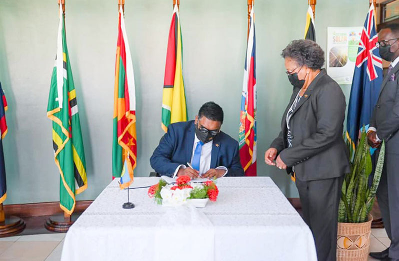 President Dr. Irfaan Ali signing the Guest Book at the CARICOM Secretariat, Liliendaal, in the presence of CARICOM Secretary-General, Dr. Carla Barnett