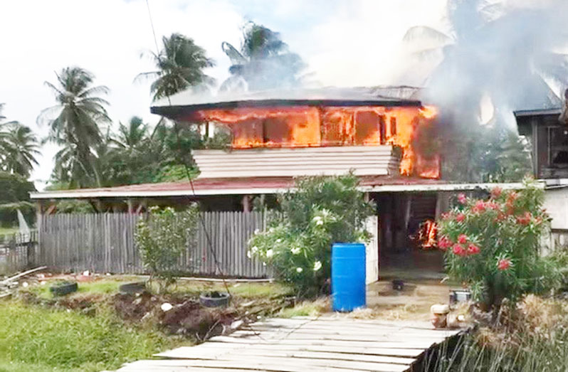 The two-storey wooden and concrete house on fire