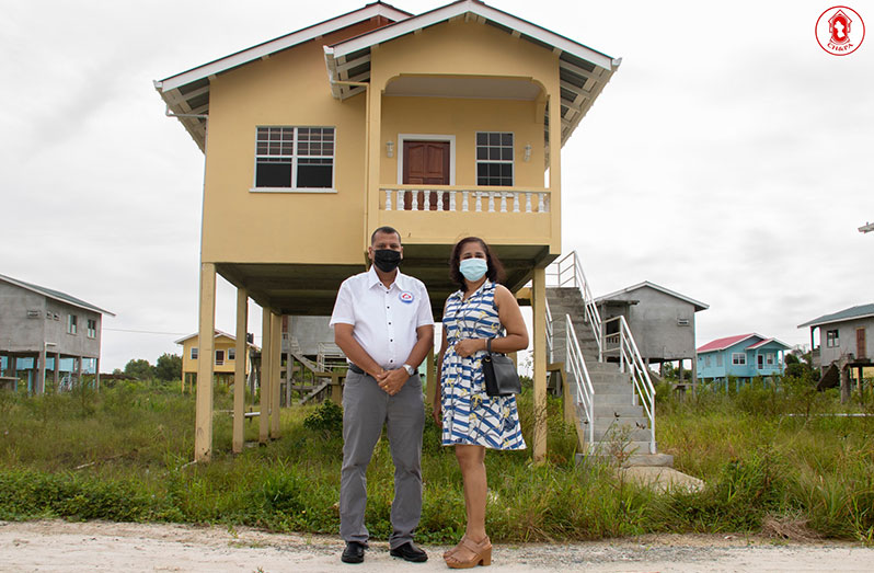 Minister of Housing and Water Collin Croal with new homeowner Indranie Lallchandra at Cummings Lodge (Ministry of Housing photo)
