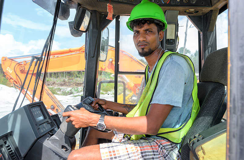 Navin Dinanath operates the heavy-duty machinery that facilitates the loading of sand on ships (Delano Williams photos)