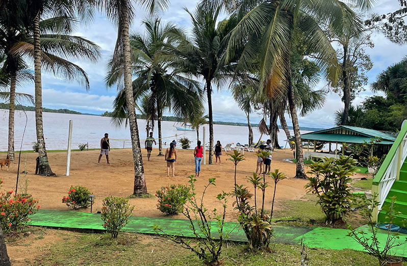 Young Guyanese enjoying a game of volleyball on the beach at the Hurakabra Tourist Resort on the Essequibo River