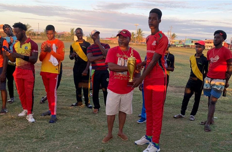 Achievers U21’s skipper Jayden Samuels collects the Brentnol Woodford championship trophy.